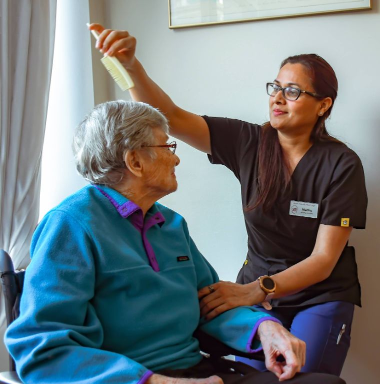 elderly women receiving care from care worker