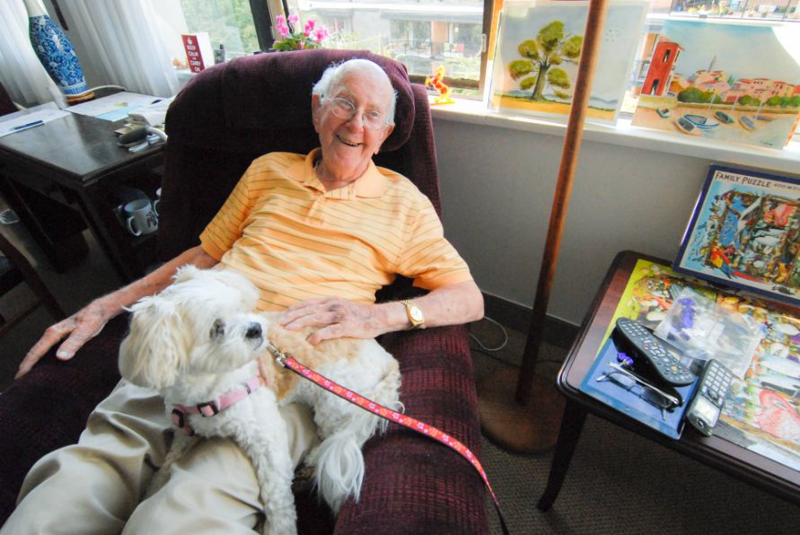 Elderly_man_with_a_dog smiling at camera in Shaughnessy