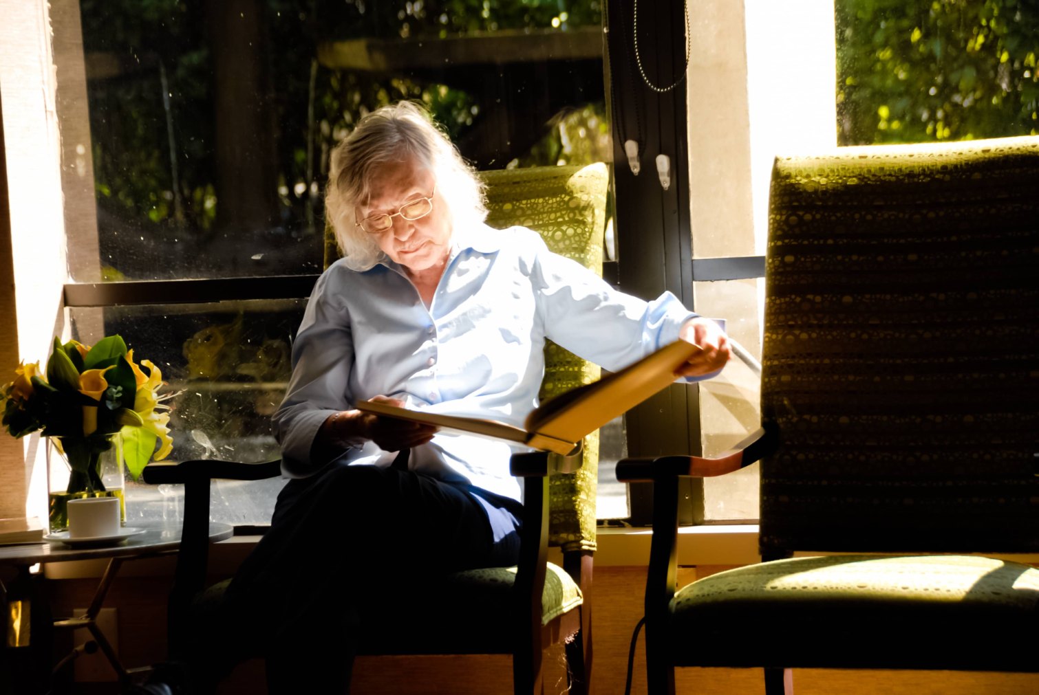 Elderly_woman_reading a book by window in Shaughnessy