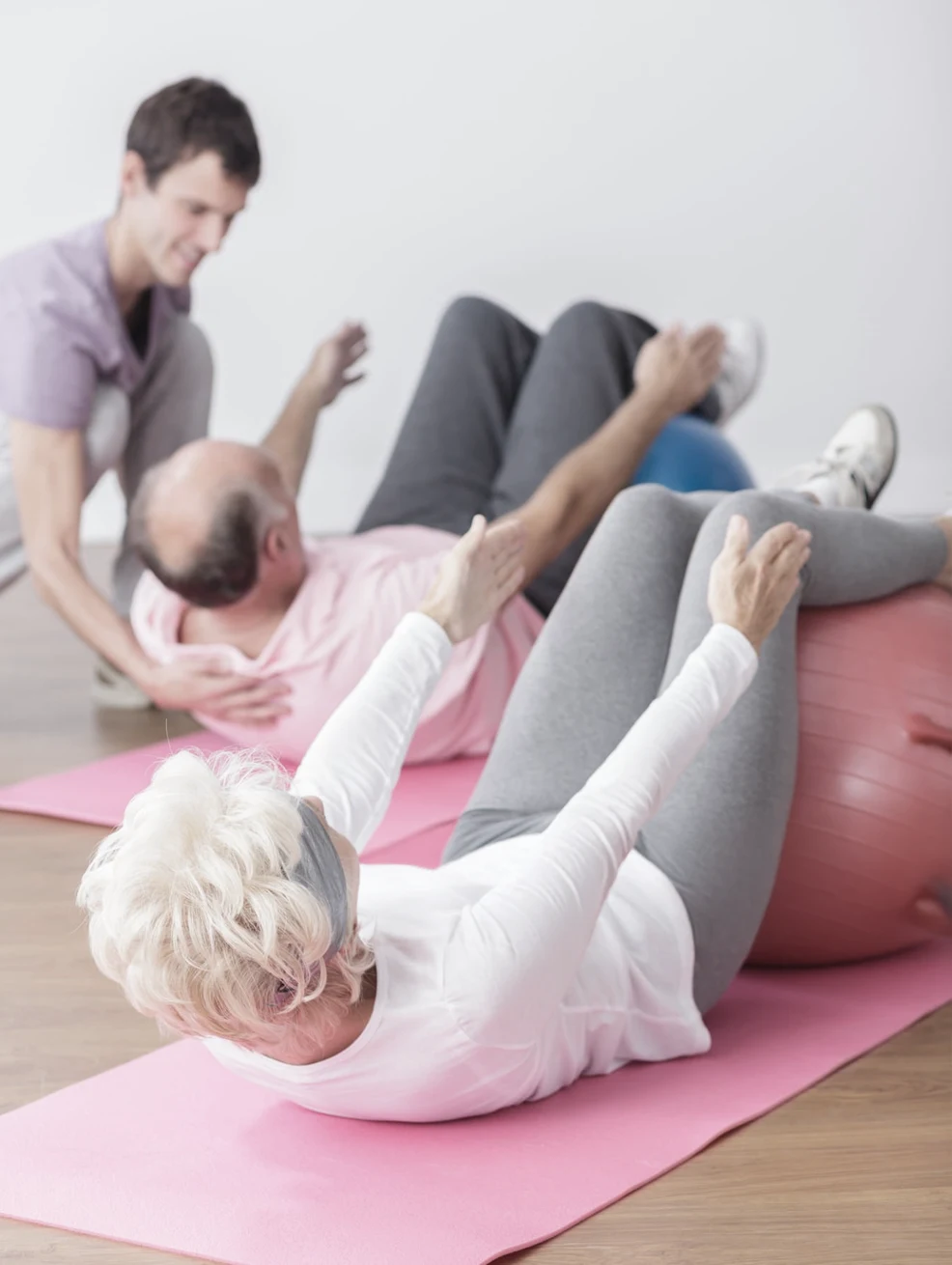 Image of elderly couple during training at gym